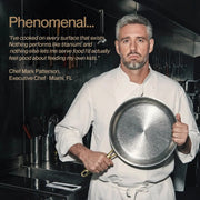 Chef Mark Patterson in a white chef coat holds a hammered stainless steel frying pan in a professional kitchen setting. Text on the left reads 'Phenomenal.